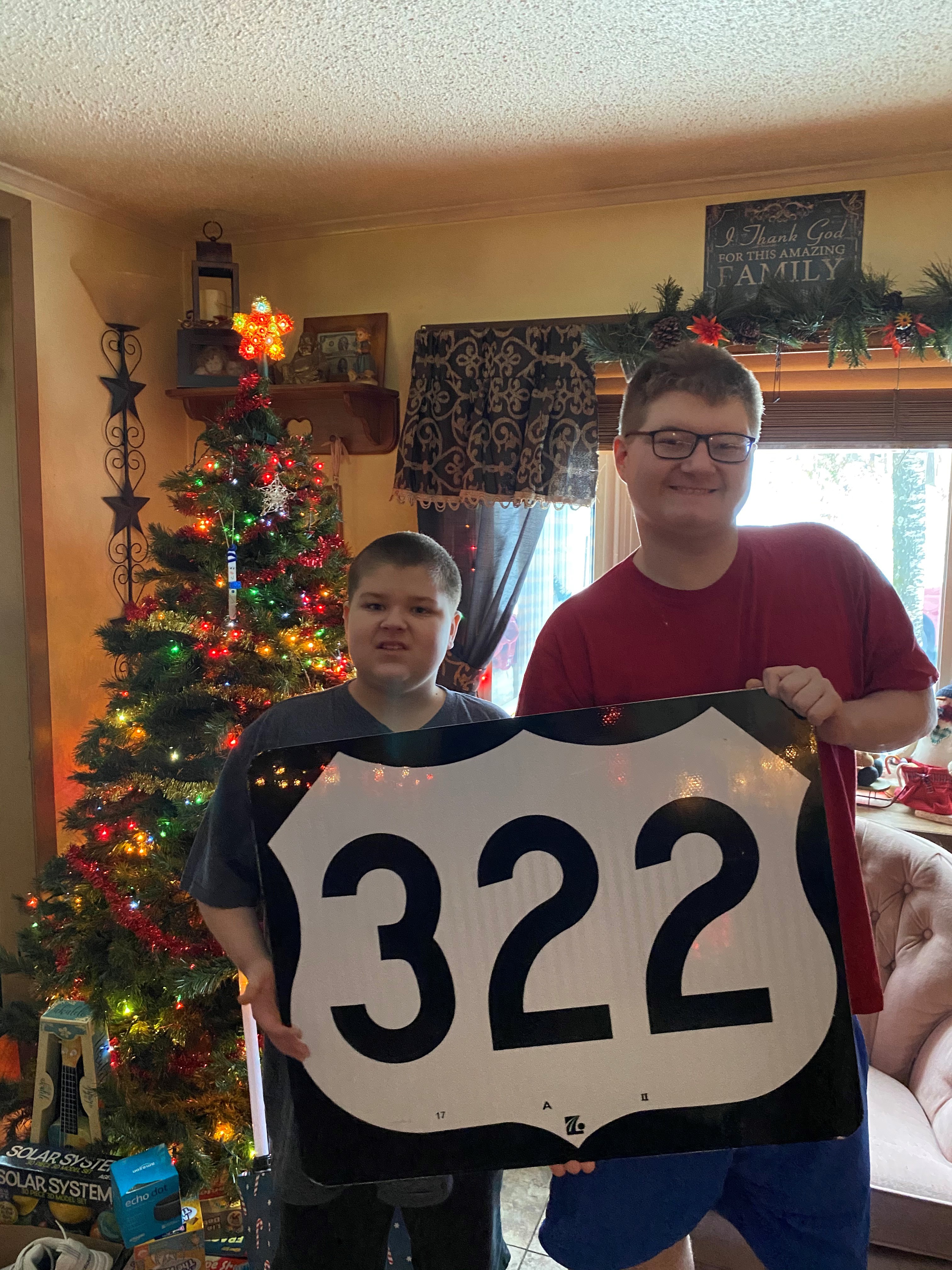 Parker and William Bowman holding Route 322 sign