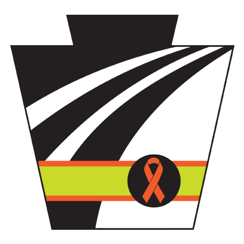 Black and white PennDOT Keystone logo with a thick yellow stripe bordered with a thin orange stripe and an orange ribbon in the black dot.