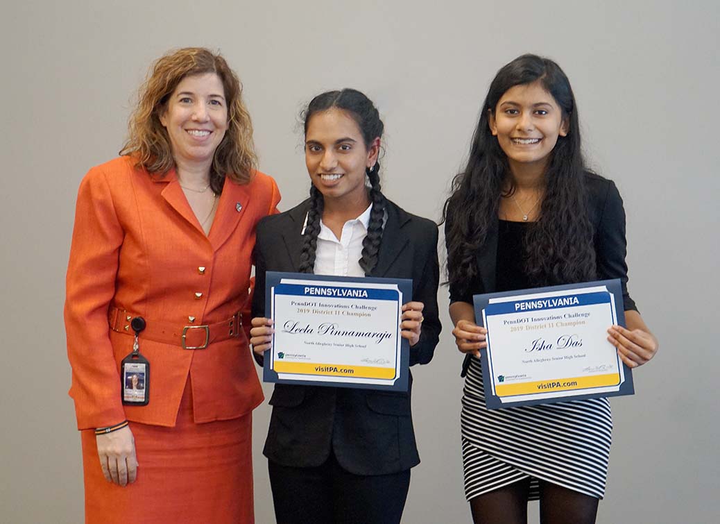 From left, PennDOT Secretary Leslie S. Richards, Leela Pinnamaraju and Isha Das holding certificates.