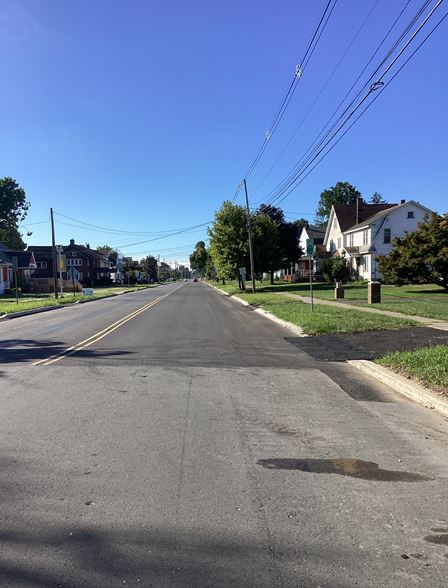 Section of newly paved and painted roadway on a residential street.