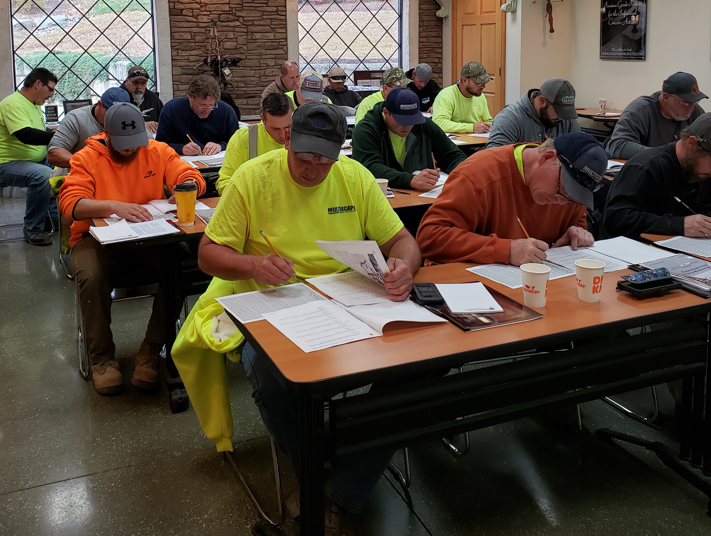 Certified Concrete Finishers Course participants sitting in classroom filling out paperwork.