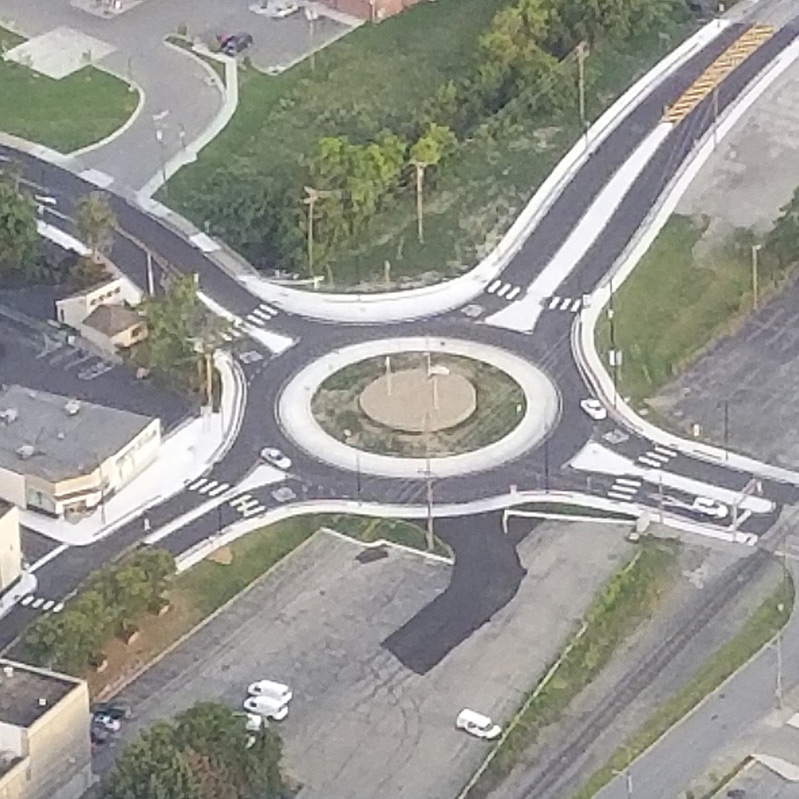 A newly constructed roundabout without any cards on the road.