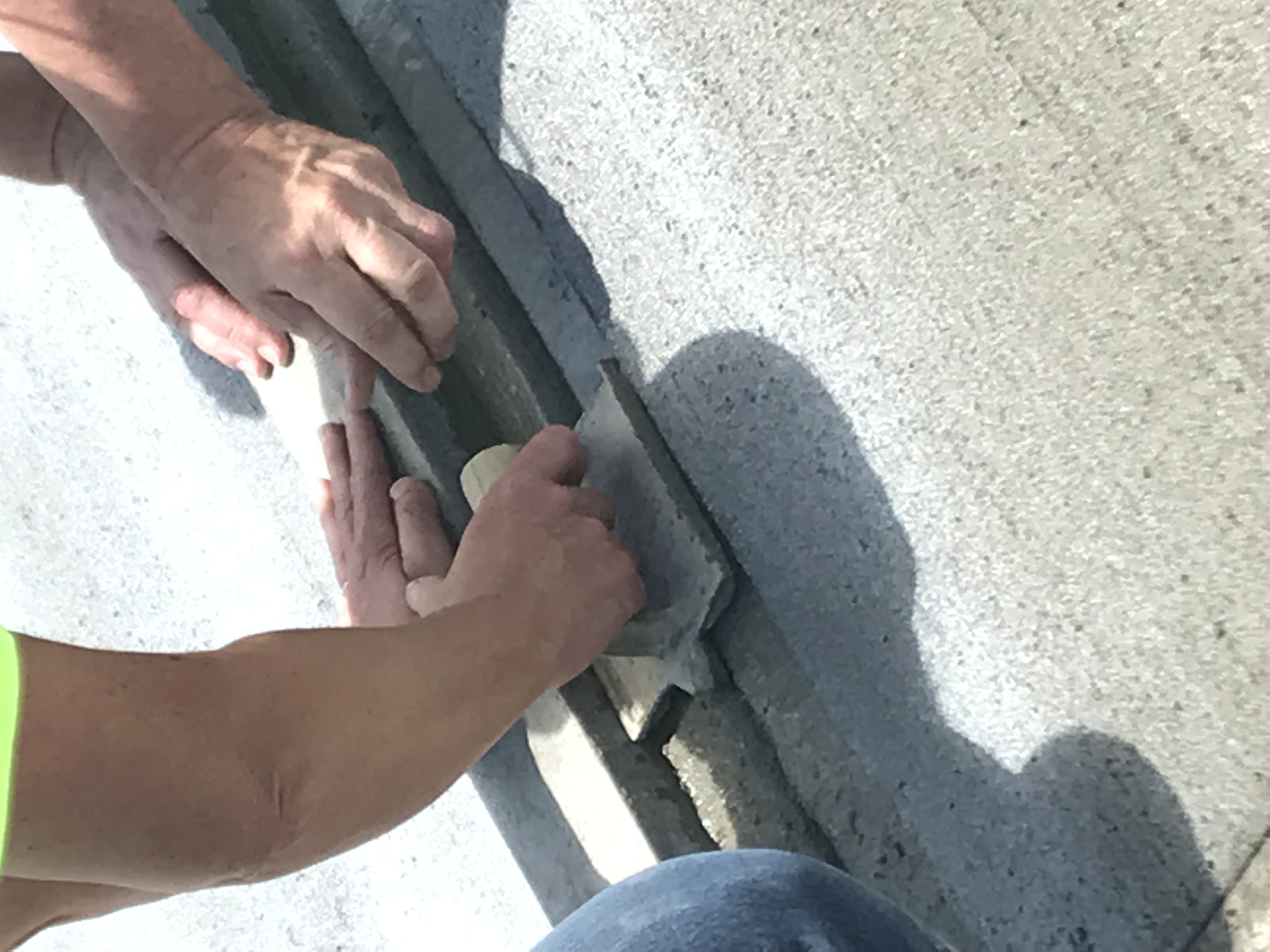close-up of finishers curing concrete