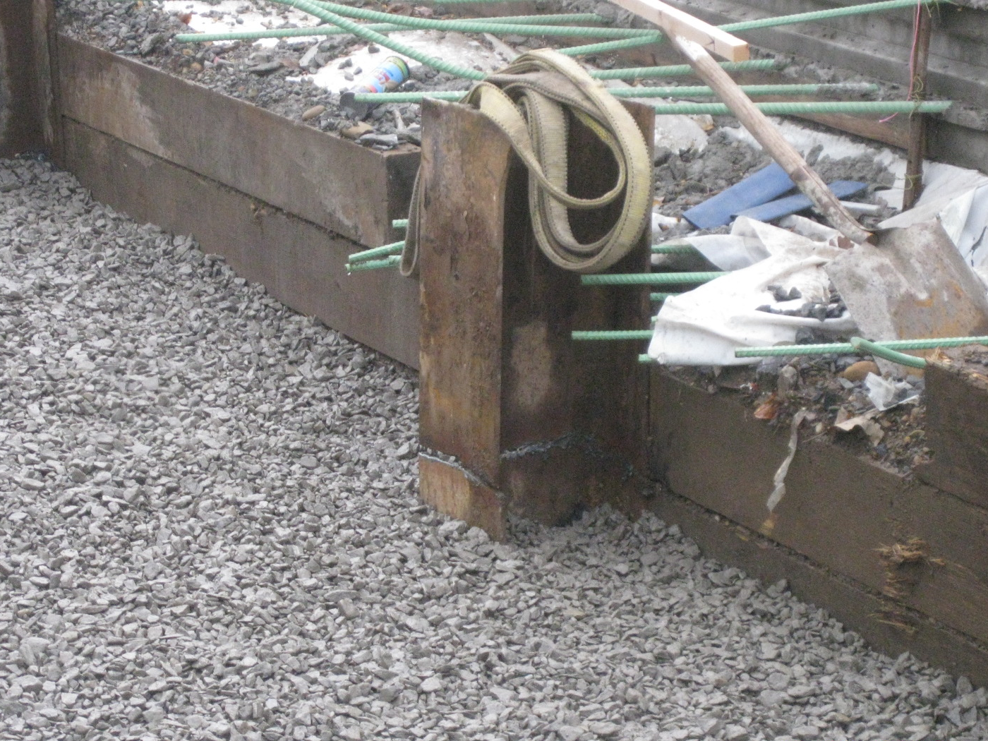 Gravel around steel beam at bridge construction site.