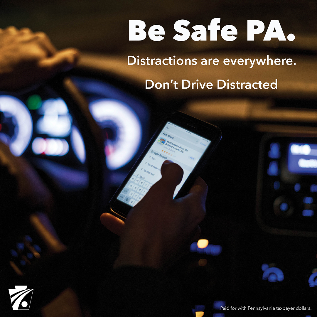 Image of driver using cell phone while driving at night with text reading Be Safe PA. Distractions are everywhere. Don't Drive Distracted.
